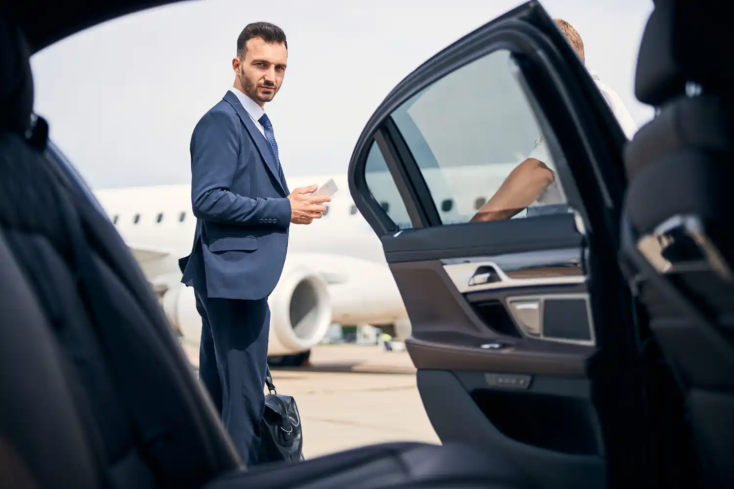DirectWay Cars driver with name board at Heathrow Arrivals